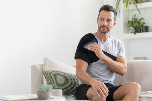 Man applying a cold pack with an adjustable shoulder support